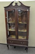 An Edwardian mahogany display cabinet, with broken swan neck cornice,