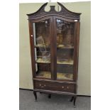 An Edwardian mahogany display cabinet, with broken swan neck cornice,