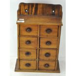 An eight drawer wall mounting spice cupboard,