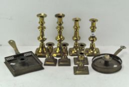 Four sets of brass candlesticks all on square bases,