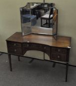 A mahogany and inlay dressing table, with brass handles and topped with a mirror,