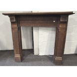 A 20th century oak fire surround in the Art Deco style,