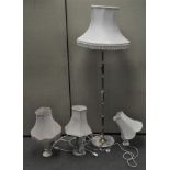 A group of four assorted lamps, comprising three table lamps and one standard lamp, all with shades,