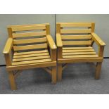 A pair of modern wooden garden armchairs, slatted seats and back rest,