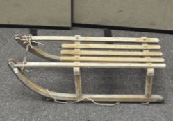 A traditional wooden sledge, with metal fittings,