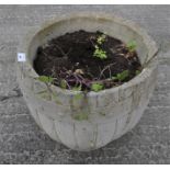 A stone garden pot modelled as a barrel,