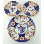 Three Japanese Imari plates, with fluted rims,