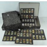 A collection of assorted cigarette cards,