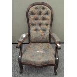 A Victorian button back walnut armchair, covered in a floral fabric,