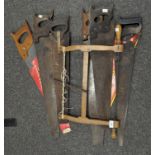 A collection of saws, including one by Spear & Jackson,