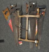 A collection of saws, including one by Spear & Jackson,