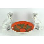 A pair of white glazed Staffordshire dogs together with a Poole pottery bowl with green decorations