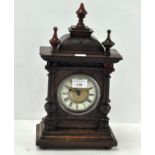 A late 19th/early 20th century German clock, the enamel and gilt dial with Roman numerals,