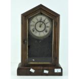 A mid century American mantel clock, wooden cased, the dial with Roman numerals denoting hours,