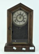 A mid century American mantel clock, wooden cased, the dial with Roman numerals denoting hours,