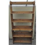 A 20th century pine bookcase with graduated shelves,