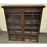 A Victorian glass fronted mahogany bookcase, two doors opening to reveal four wooden shelves,