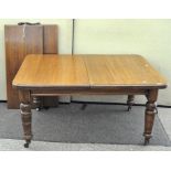 A rectangular oak, extending dining table, on tapering, turned legs with 2 extra leaves,
