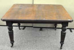 A 19th century mahogany dining table, raised on turned supports,