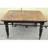 A 19th century mahogany dining table, raised on turned supports,