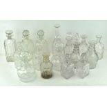 A quantity of glass decanter bottles, of assorted shapes and sizes,