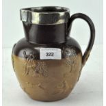 A late Victorian glazed stoneware jug with silver rim,