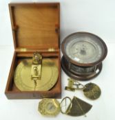 A group of six astrological items, five brass examples, including compasses, star symbols,