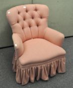 A wingback armchair upholstered in pink fabric, on cabriole feet,