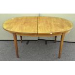 An oval extending dining table,