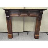 A mahogany fireplace surround,