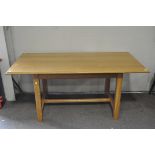 A modern oak dining table of rectangular form,