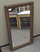 A gilt framed wall mirror of rectangular form,