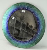 A modern wall mirror of circular form with reflective mosaic style frame,