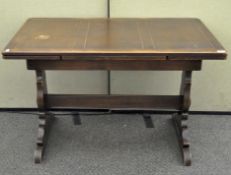 An Ercol draw leaf dining table of rectangular form.