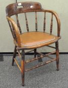 An oak tub chair with turned supports, the seat itself with riveted border,