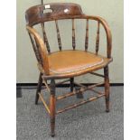 An oak tub chair with turned supports, the seat itself with riveted border,