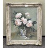 An oil on canvas depicting a floral still life, flowers in a vase, framed,