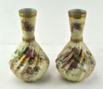 A pair of Royal Worcester blush ivory vases, with conical necks and wrythen body,