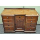 A Victorian mahogany reverse breakfront sideboard, with nine drawers around a central cupboard,