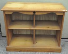 A pine storage cupboard, split into four compartments,