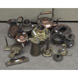A collection of assorted brassware, including kettles,