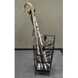 A group of walking sticks with wooden handles, assorted lengths and designs,