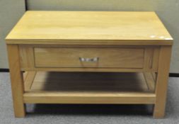 A modern oak coffee table of rectangular form, with single drawer to one side,