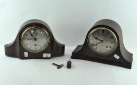 Two mantle clocks, one oak cased, the dial with Roman numerals denoting hours,