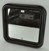 A Habitat wall mirror with rounded corners,