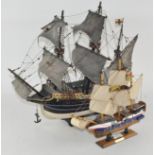 Two wooden model ships, each with two masts, both titled "the Golden Hind",
