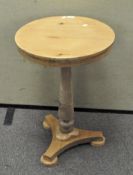 A round pine small occasional table on turned column and triform base,