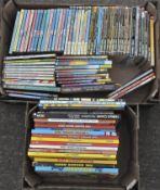 A collection of children's books, including Beano Annuals,