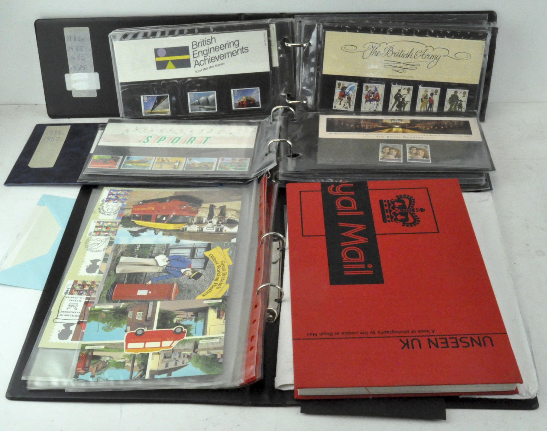 A collection of ephemera, including Royal Mail stamps, postcards,