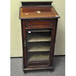 A Victorian mahogany music cabinet, the glazed front opening to reveal five tiers,